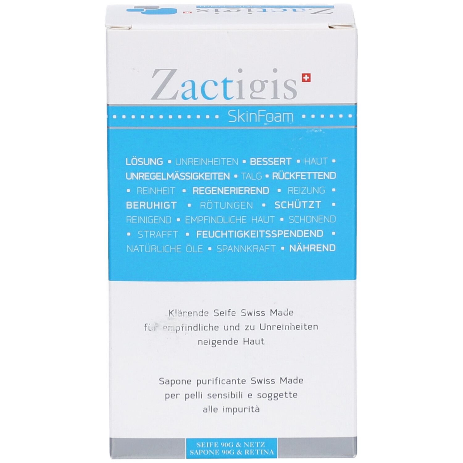 Wit en blauw doosje. Opschrift: Zactigis SkinFoam. Tekst in het Duits, Frans en Italiaans. Zuiverende zeep voor de gevoelige huid.
