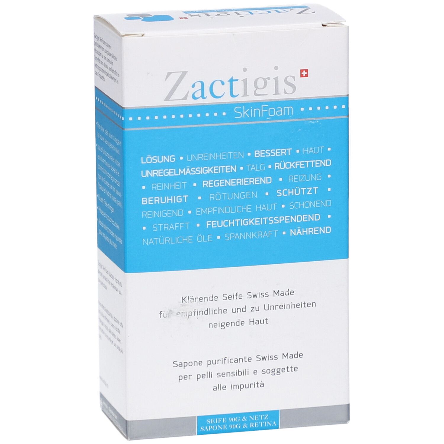 Wit en blauw doosje. Opschrift: Zactigis SkinFoam. Tekst in het Duits, Frans en Italiaans. Schuine weergave van het product.