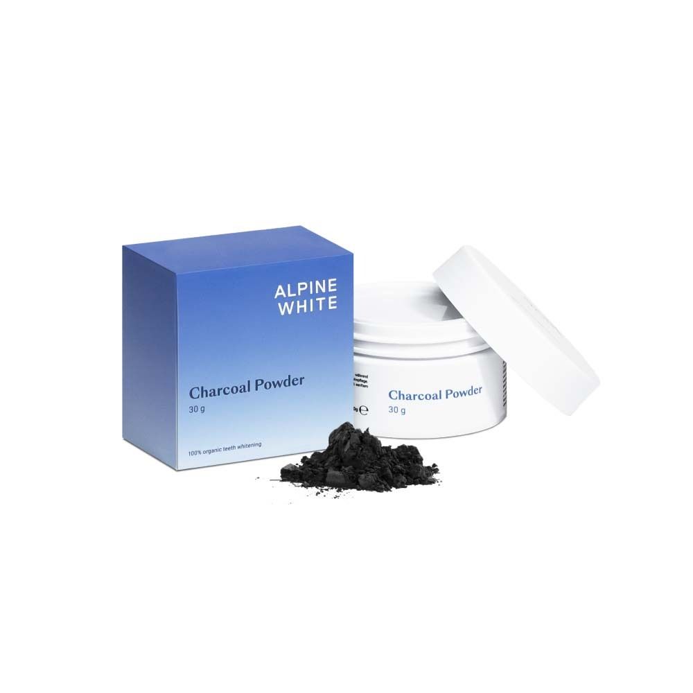 Boîte et pot bleus et blancs avec "Charcoal Powder". Poudre noire à côté. 30g. Blanchiment des dents 100% organique.