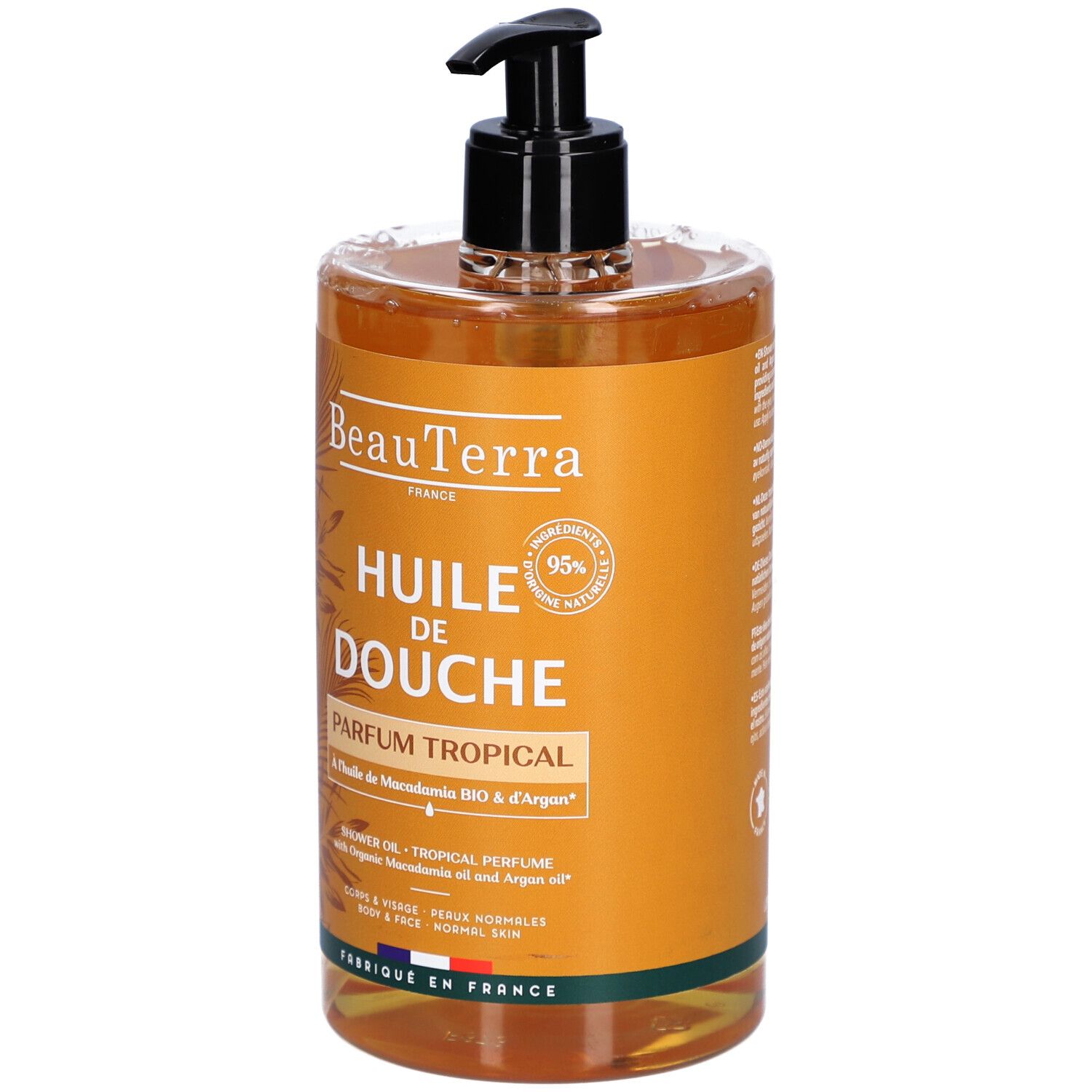 Transparante fles met zwarte pomp. Opschrift: "Huile de Douche Parfum Tropical".