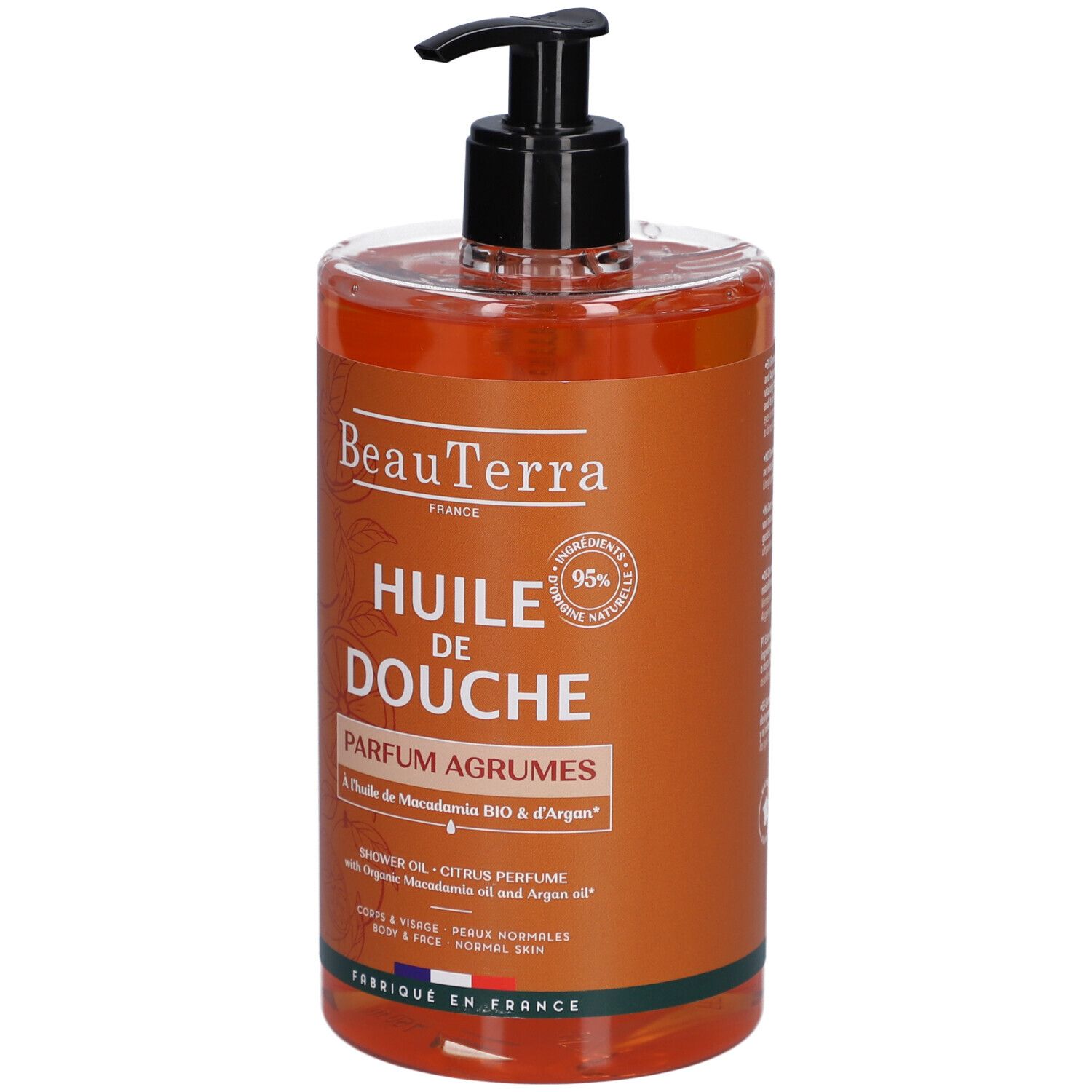 Flacon Beauterra Huile de Douche Parfum Agrumes. Huile orange avec pompe noire. Inscription: Huile de Douche, Parfum Agrumes.