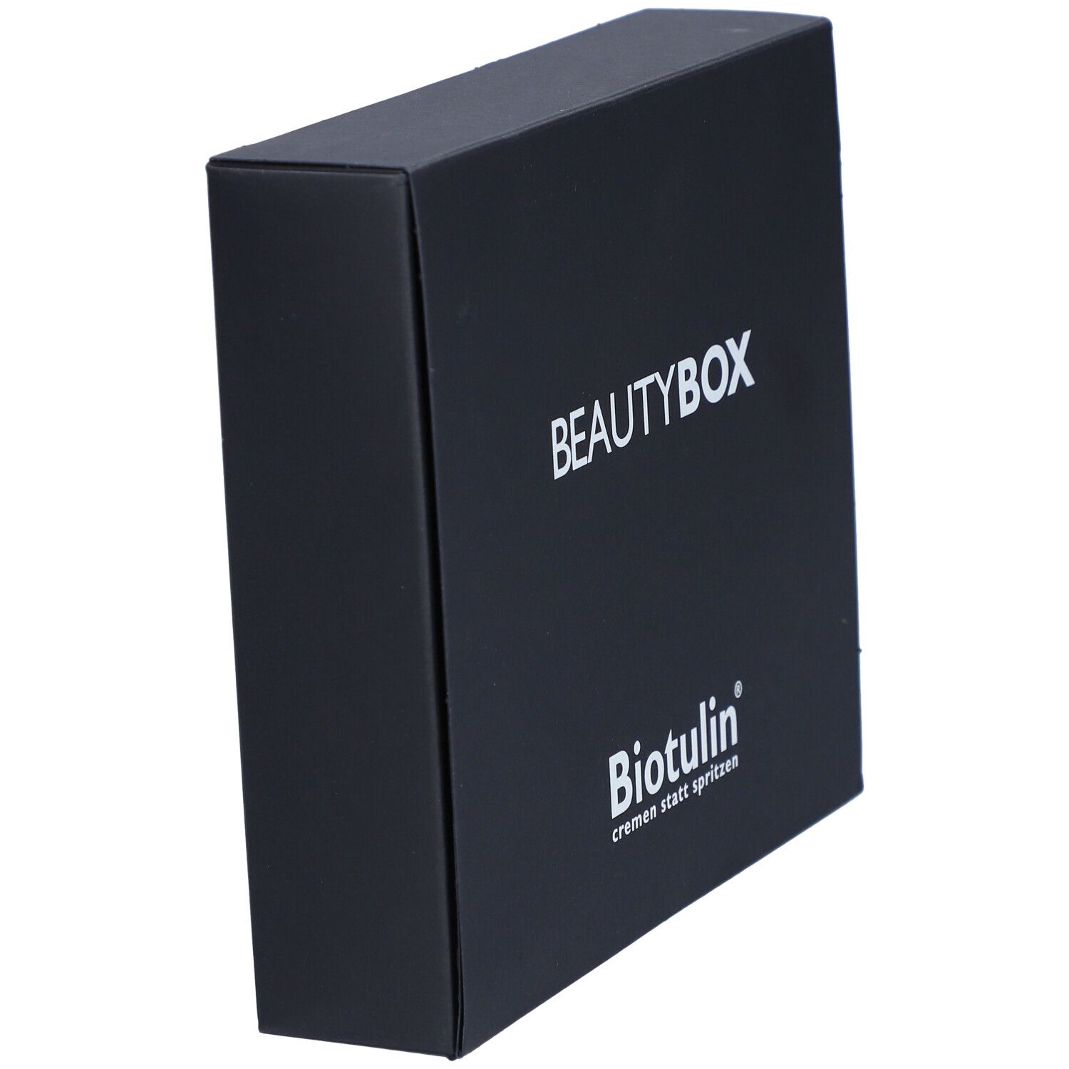 Boîte noire BEAUTYBOX, vue en biais. Inscription BEAUTYBOX et logo BIOTULIN. Texte: cremen statt spritzen.