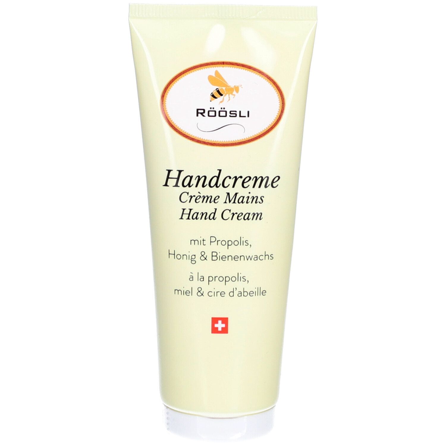 Crèmetube met logo en tekst. Bevat propolis, honing en bijenwas. Zwitsers kruis.