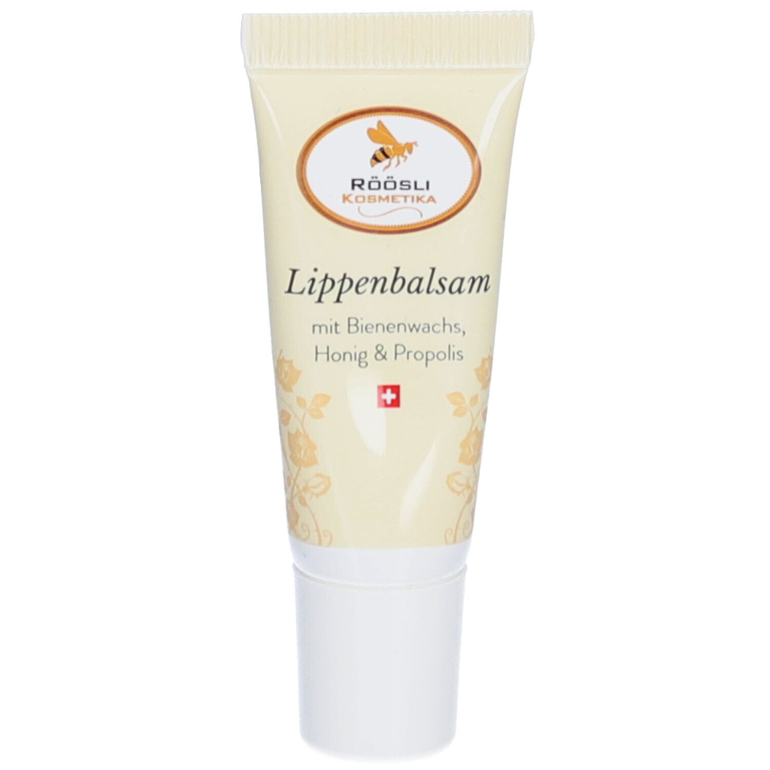 Tube de baume à lèvres. Inscription: RÖÖSLI Kosmetika, Baume à lèvres avec cire d'abeille, miel et propolis. Croix suisse.