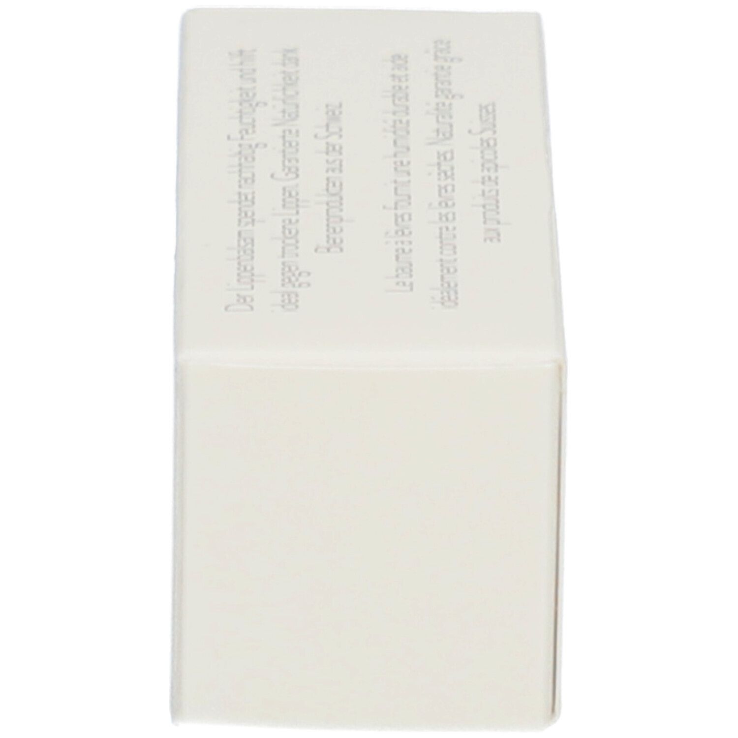 Boîte de baume à lèvres. Vue latérale. Texte en allemand et en français.