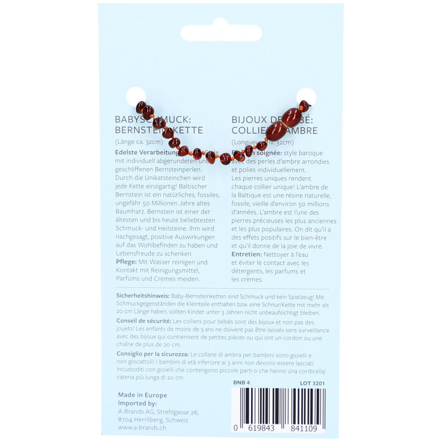 Dos du collier de bébé en ambre. Informations textuelles en allemand et en français. Style baroque, couleur cognac.