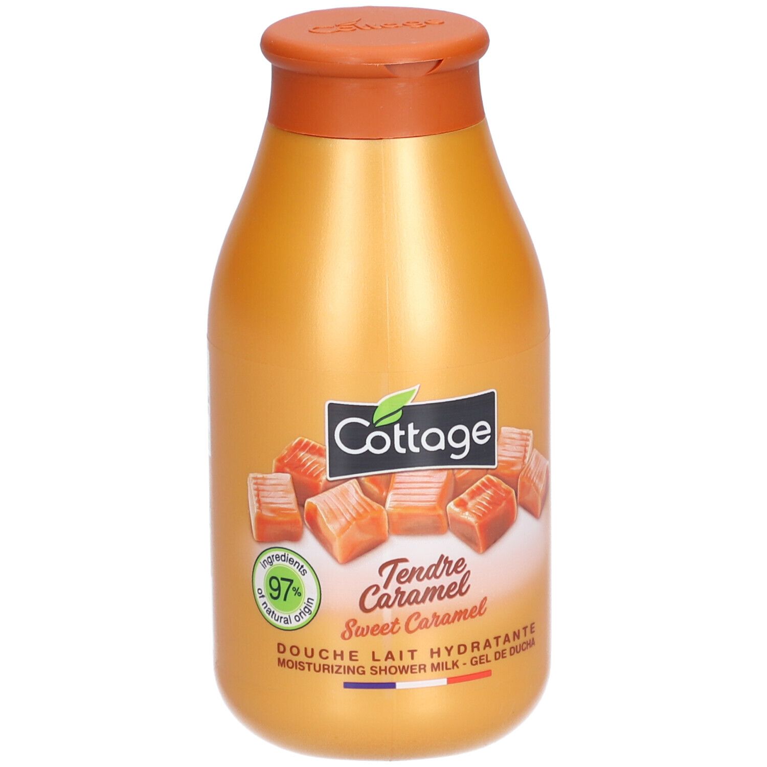 Gouden fles met bruine dop. Opschrift: Cottage, Tendre Caramel, 97% natural origin. Afbeelding van karamel snoepjes.