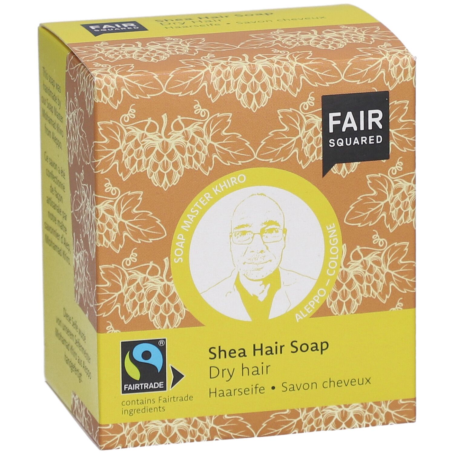 Verpakking FAIR SQUARED, afbeelding van Soap Master Khiro. Tekst: Shea Hair Soap, Dry hair. Met Fairtrade-keurmerk.