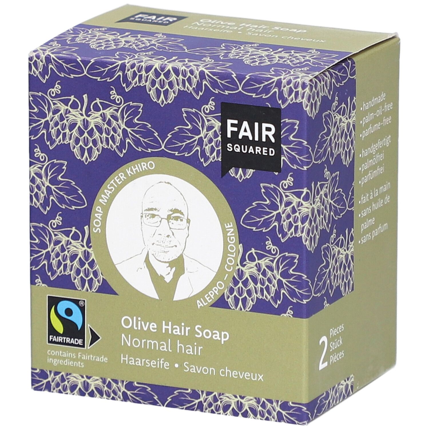 Verpakking FAIR SQUARED Haarseife Olive. Paars druivenpatroon. Fairtrade-label. Afbeelding van Soap Master Khiro.