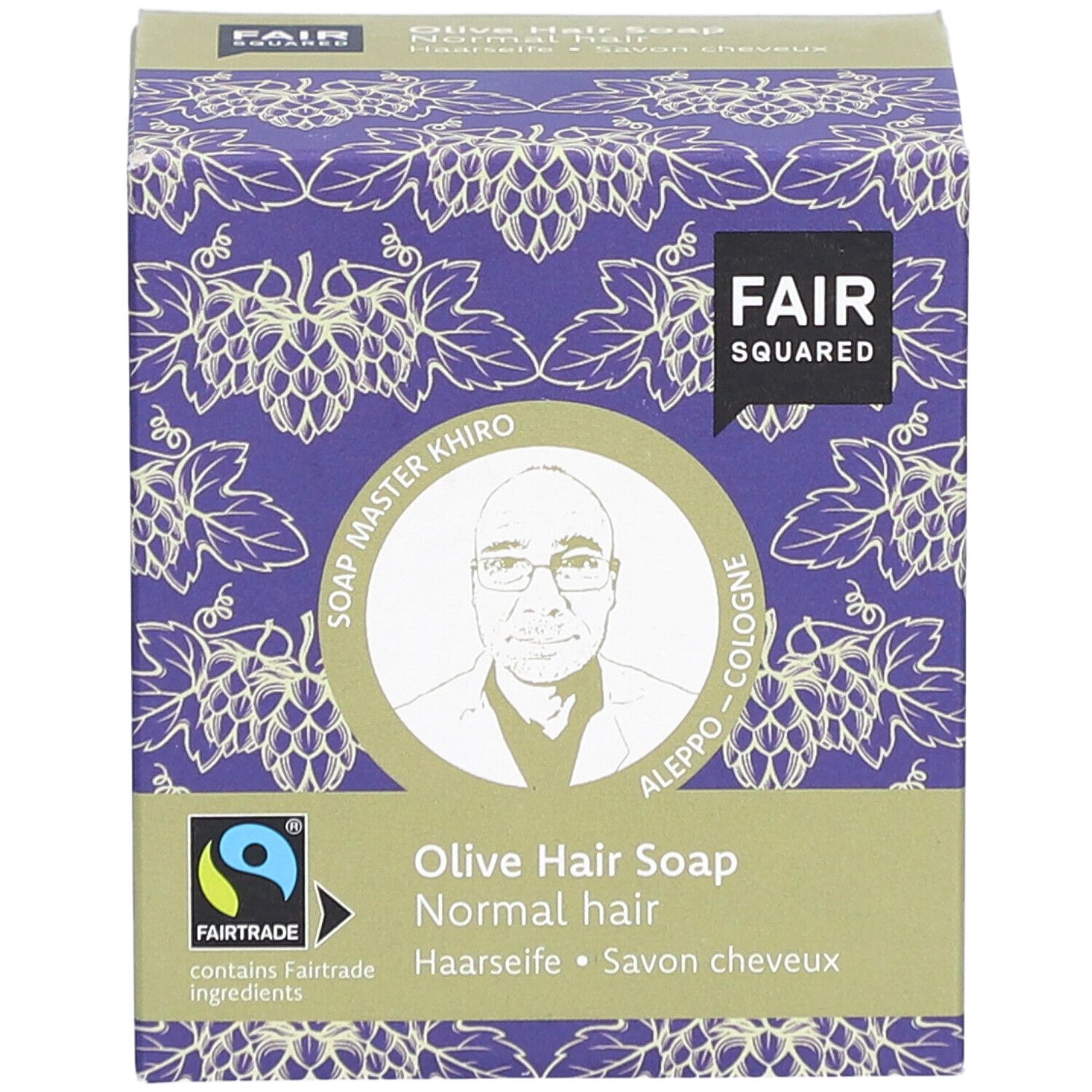 Verpakking FAIR SQUARED Haarseife Olive. Paars druivenpatroon. Fairtrade-label. Afbeelding van Soap Master Khiro.