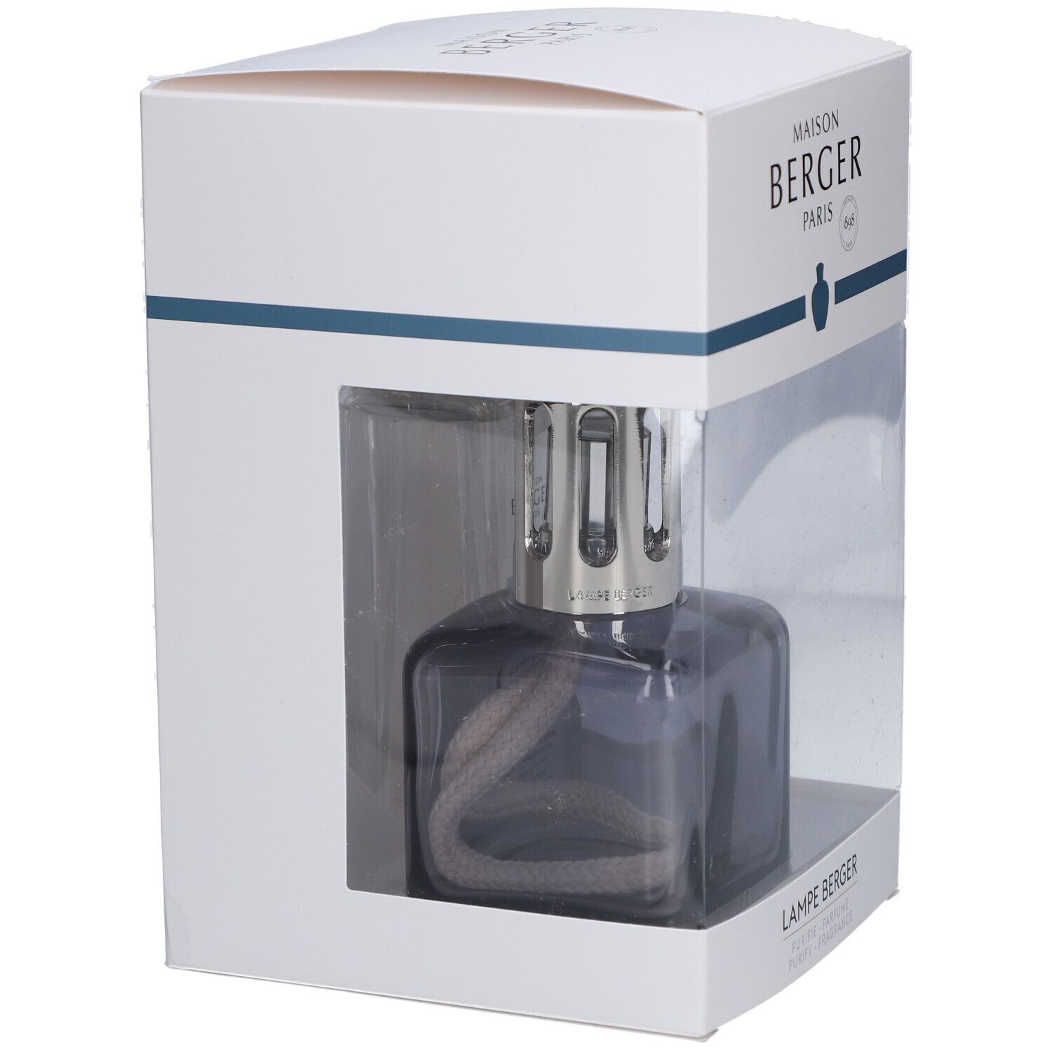 Lampe à parfum dans emballage. Lampe grise, carrée, avec mèche. Emballage blanc avec fenêtre transparente.