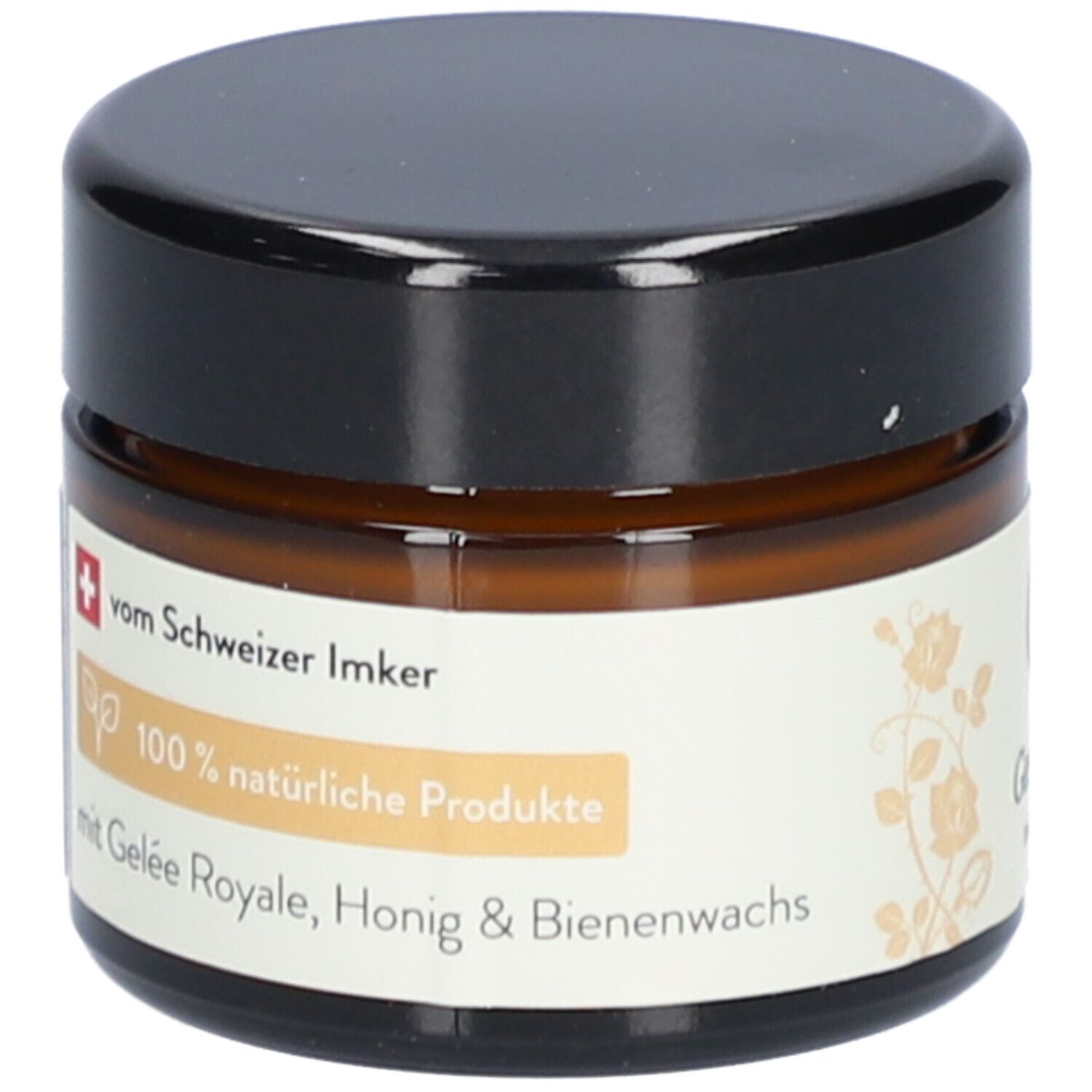 Bruine glazen pot met zwarte deksel. Label: 100% natuurlijke producten, met Gelée Royale, honing & bijenwas.