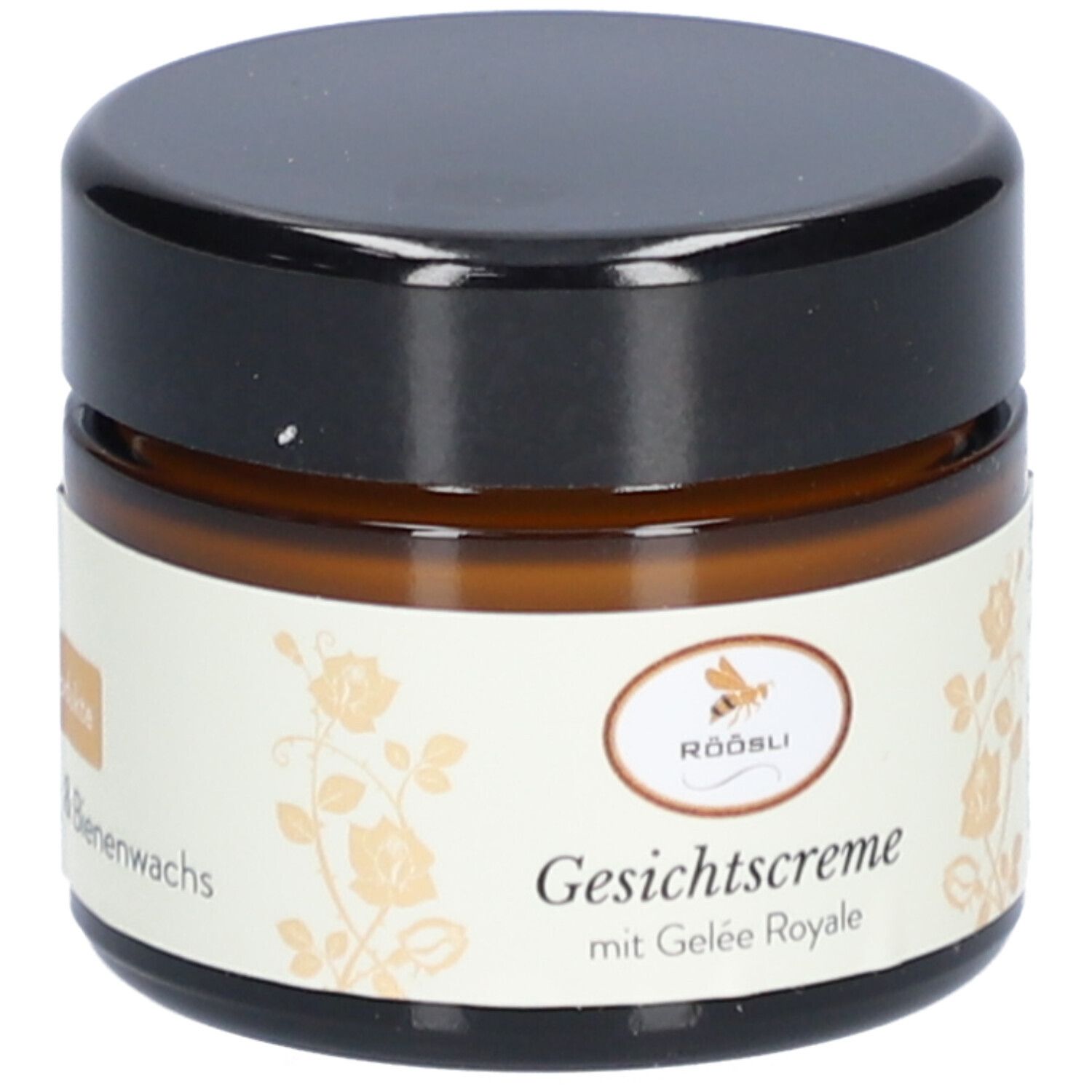 Bruine glazen pot met zwarte deksel. Label: Röösli, Crème visage met Gelée Royale, honing & bijenwas.
