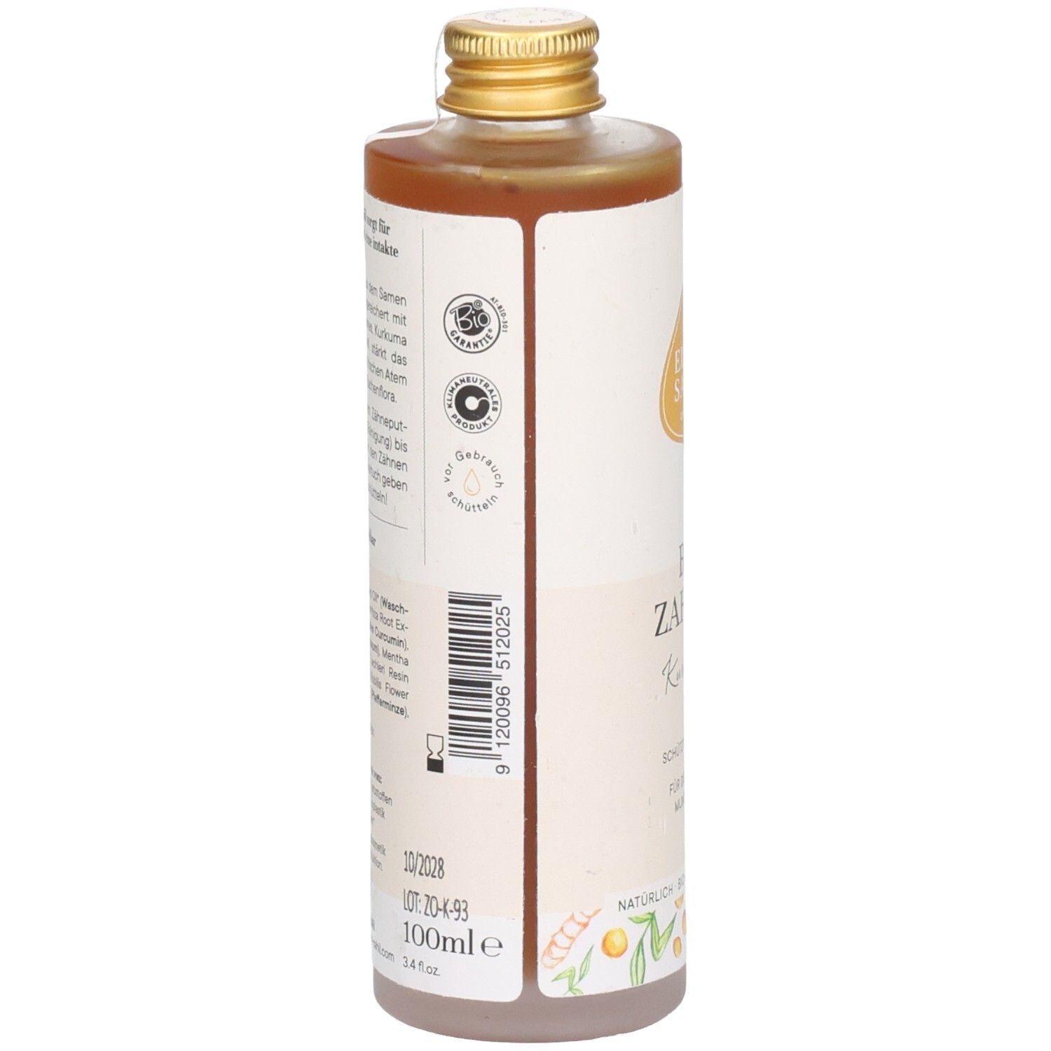 Bruine vloeistof in een cilindrische fles met gouden dop. Etiket met tekst en logo's. 100ml.