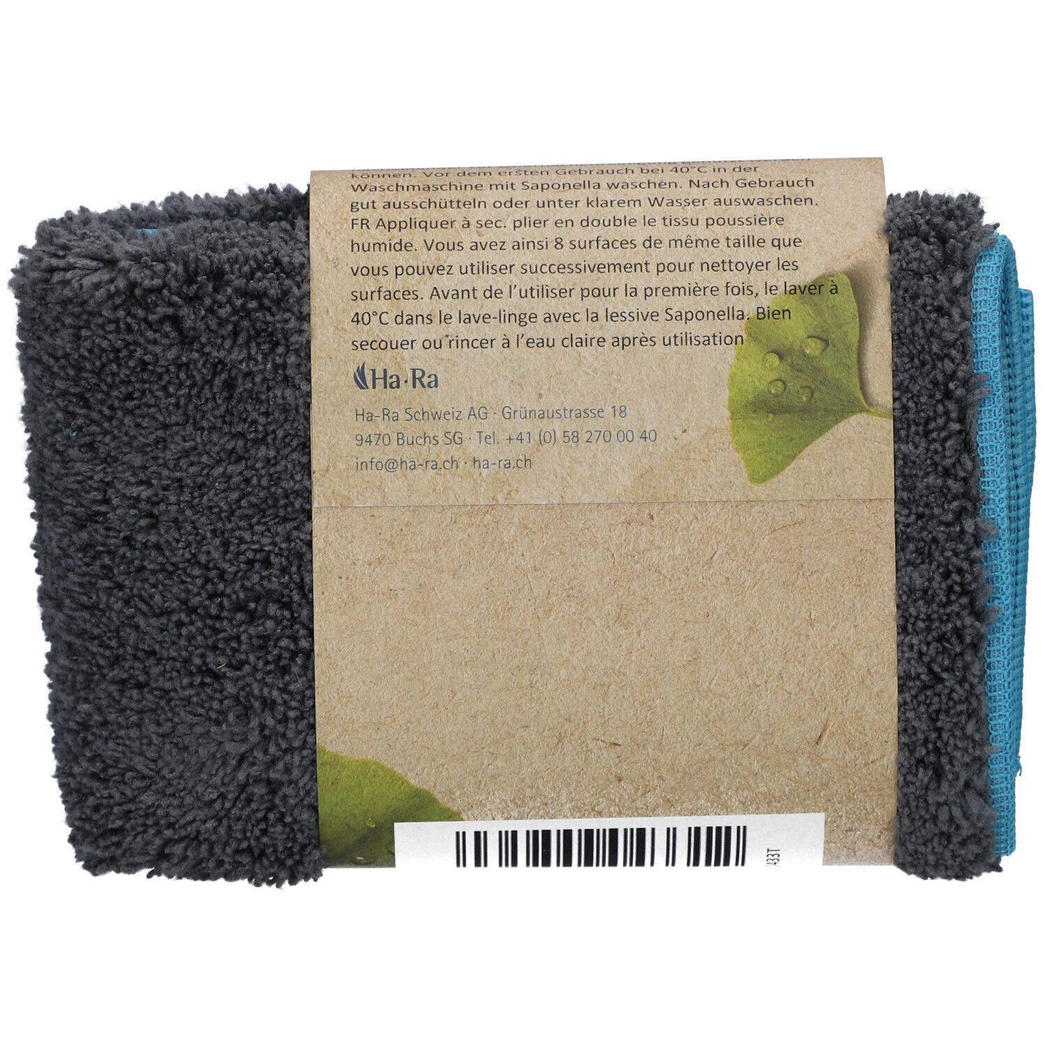 Achterkant van de opgevouwen HA-RA stofdoek. Bruine kartonnen banderol met tekst en logo. Blauwe en grijze doeken zichtbaar.