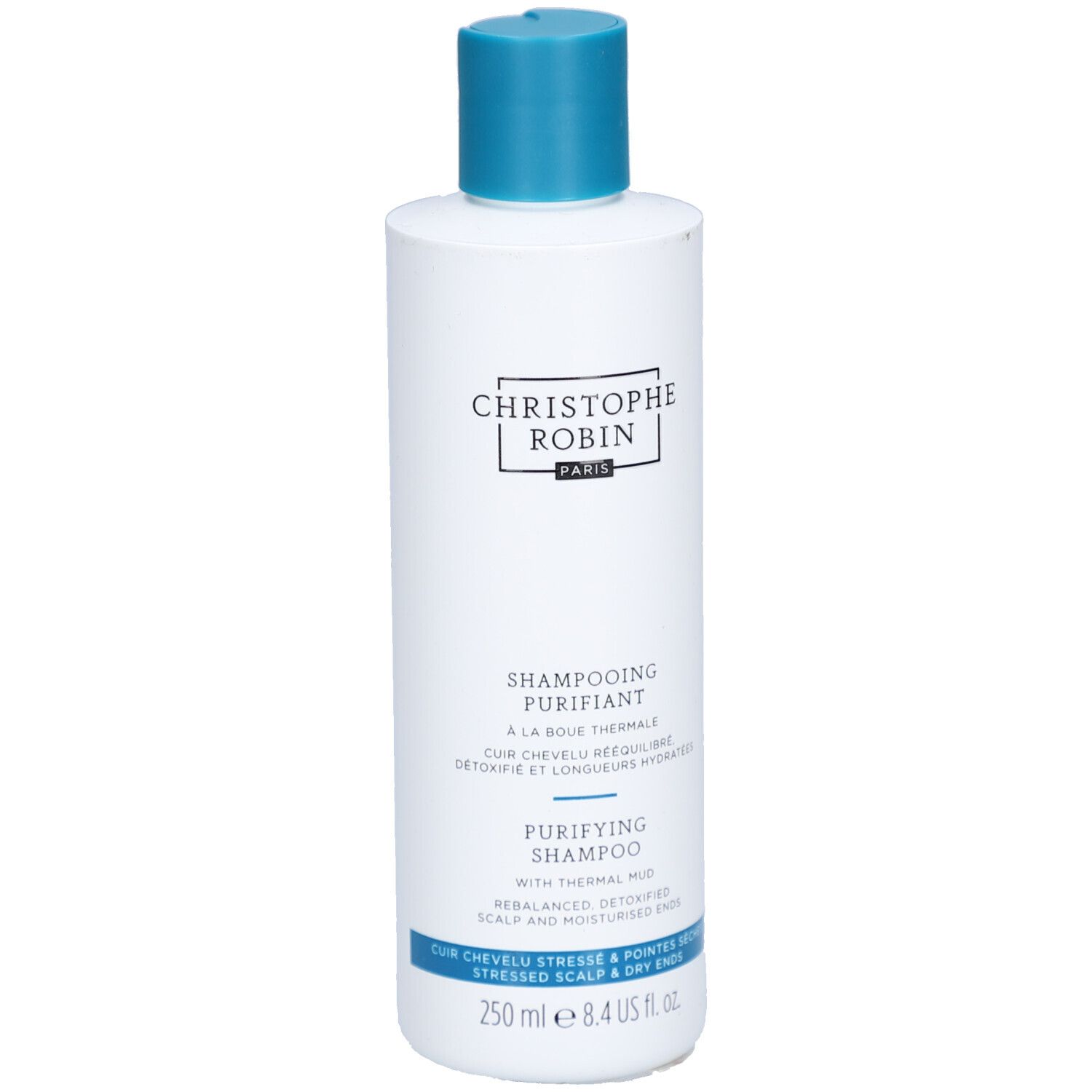 Witte fles met blauwe dop. Opschrift: CHRISTOPHE ROBIN, SHAMPOOING PURIFIANT, PURIFYING SHAMPOO. 250 ml.