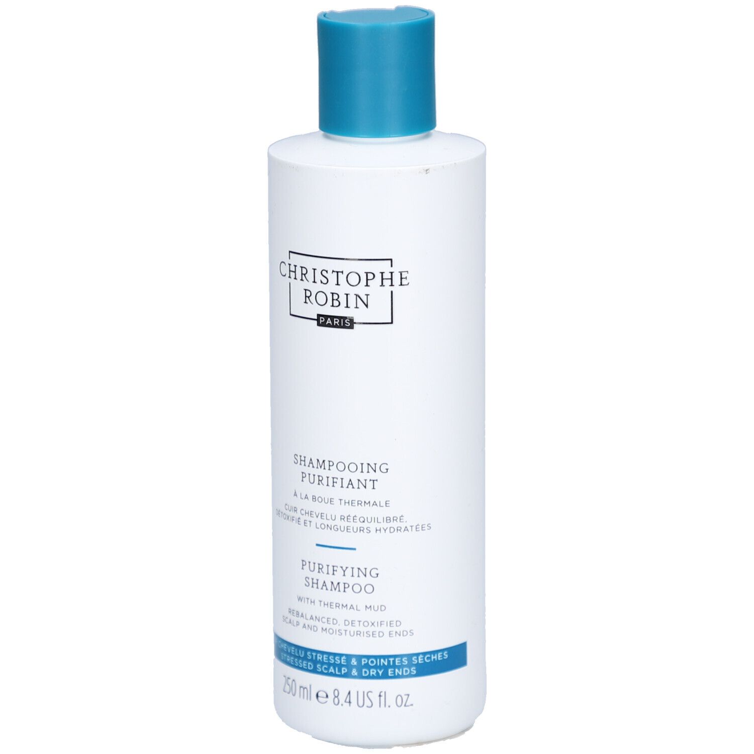 Witte fles met blauwe dop. Opschrift: CHRISTOPHE ROBIN, SHAMPOOING PURIFIANT, PURIFYING SHAMPOO. 250 ml.