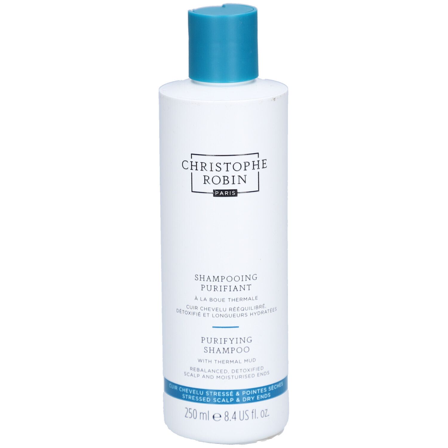 Witte fles met blauwe dop. Opschrift: CHRISTOPHE ROBIN, SHAMPOOING PURIFIANT, PURIFYING SHAMPOO. 250 ml.