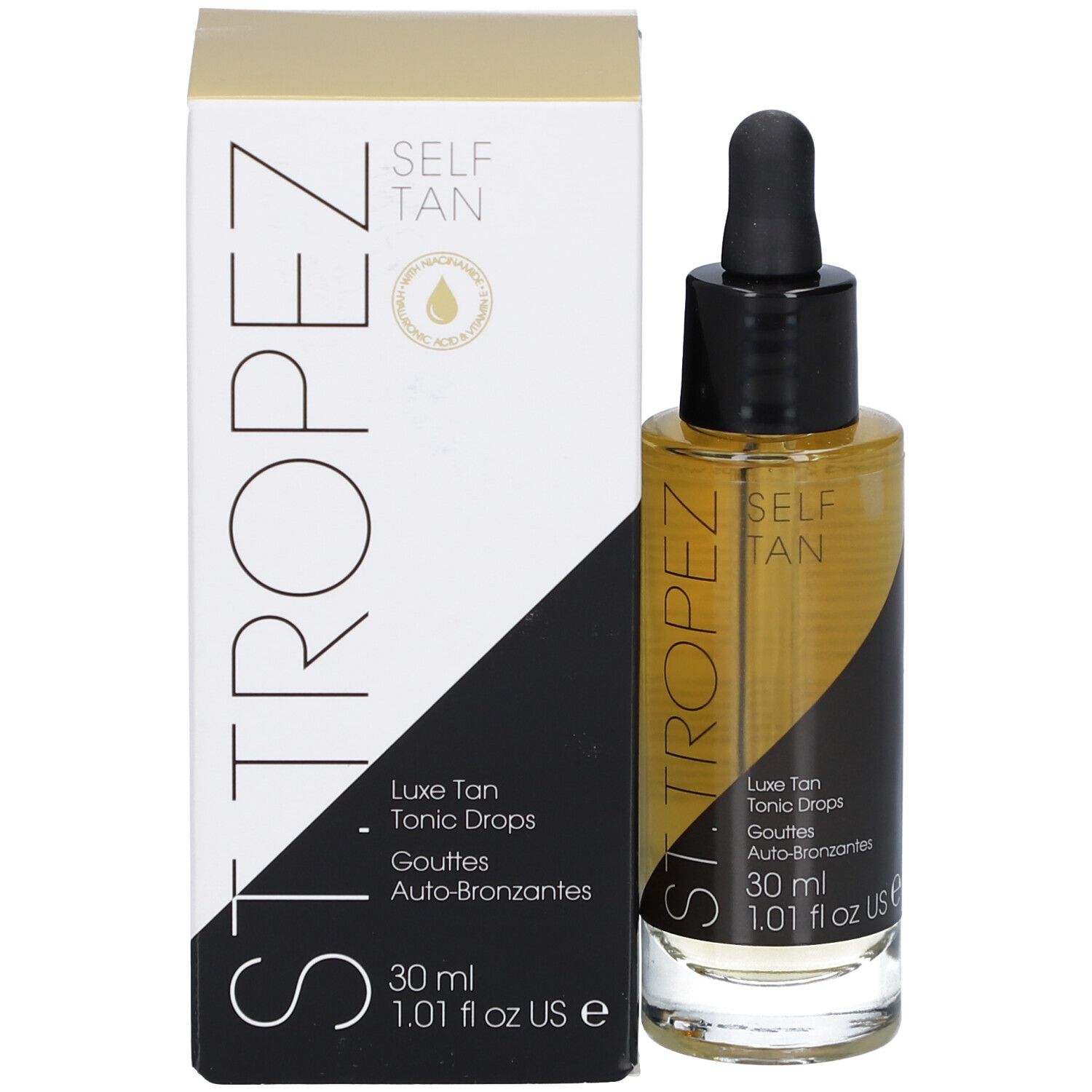 Glazen fles met bruine vloeistof en zwarte dop, naast een witte doos. Opschrift: SELF TAN, Luxe Tan Tonic Drops.