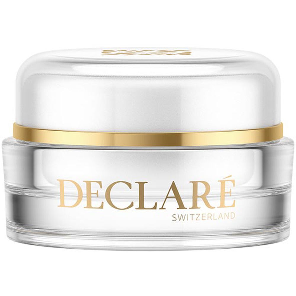 Ronde, transparante pot met wit deksel en gouden ring. DECLARÉ-opschrift in goud. Opschrift: SWITZERLAND.