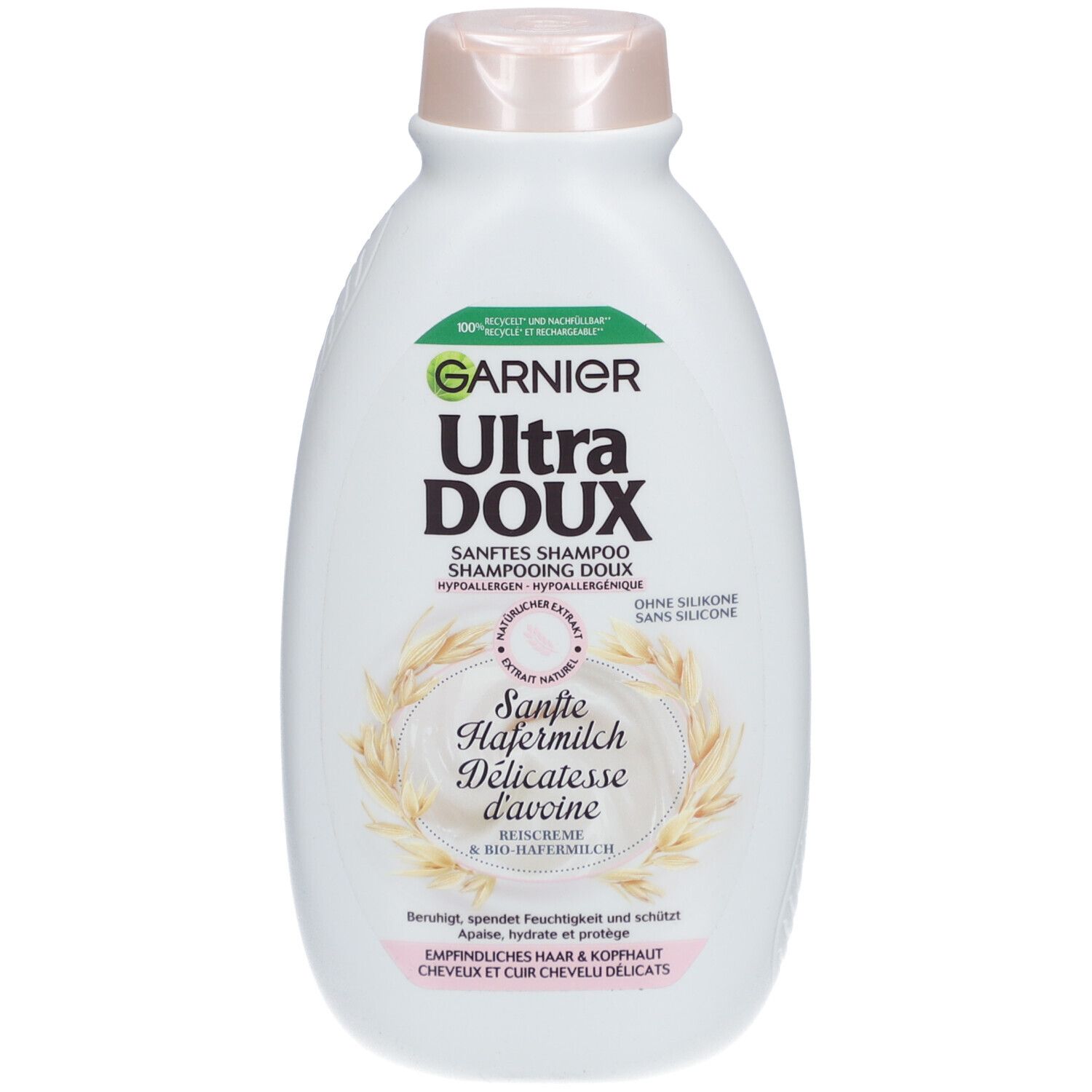 Flacon blanc, bouchon rose. Inscription: GARNIER Ultra DOUX SHAMPOOING DOUX. Extrait de lait d'avoine. Pour cheveux délicats.