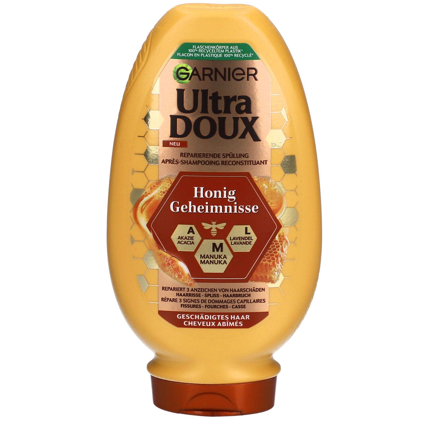 Gele fles met etiket. Tekst: GARNIER Ultra DOUX, Honig Geheimnisse. Bevat acacia-, manuka- en lavendel honing.