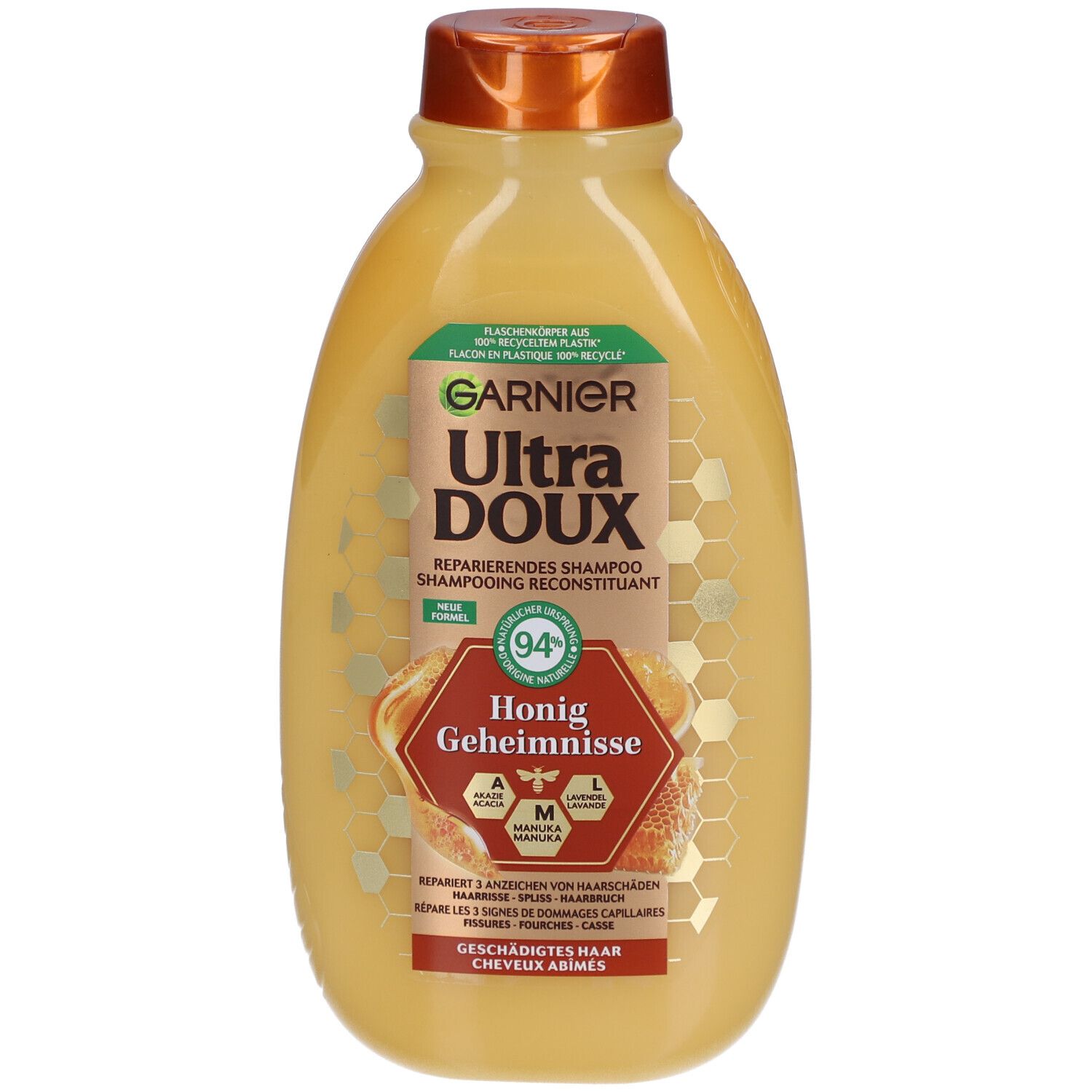 Gele fles Garnier Ultra Doux shampoo met bruine dop. Etiket met productnaam, honingillustratie en tekst.