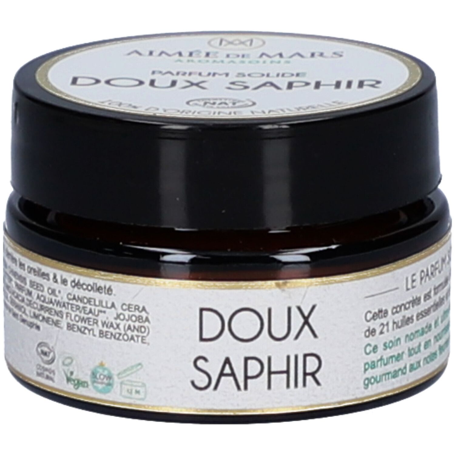 Klein, rond potje met zwarte deksel. Opschrift: Doux Saphir. Vegan-zegel. Ingrediënten en certificeringen op het etiket.