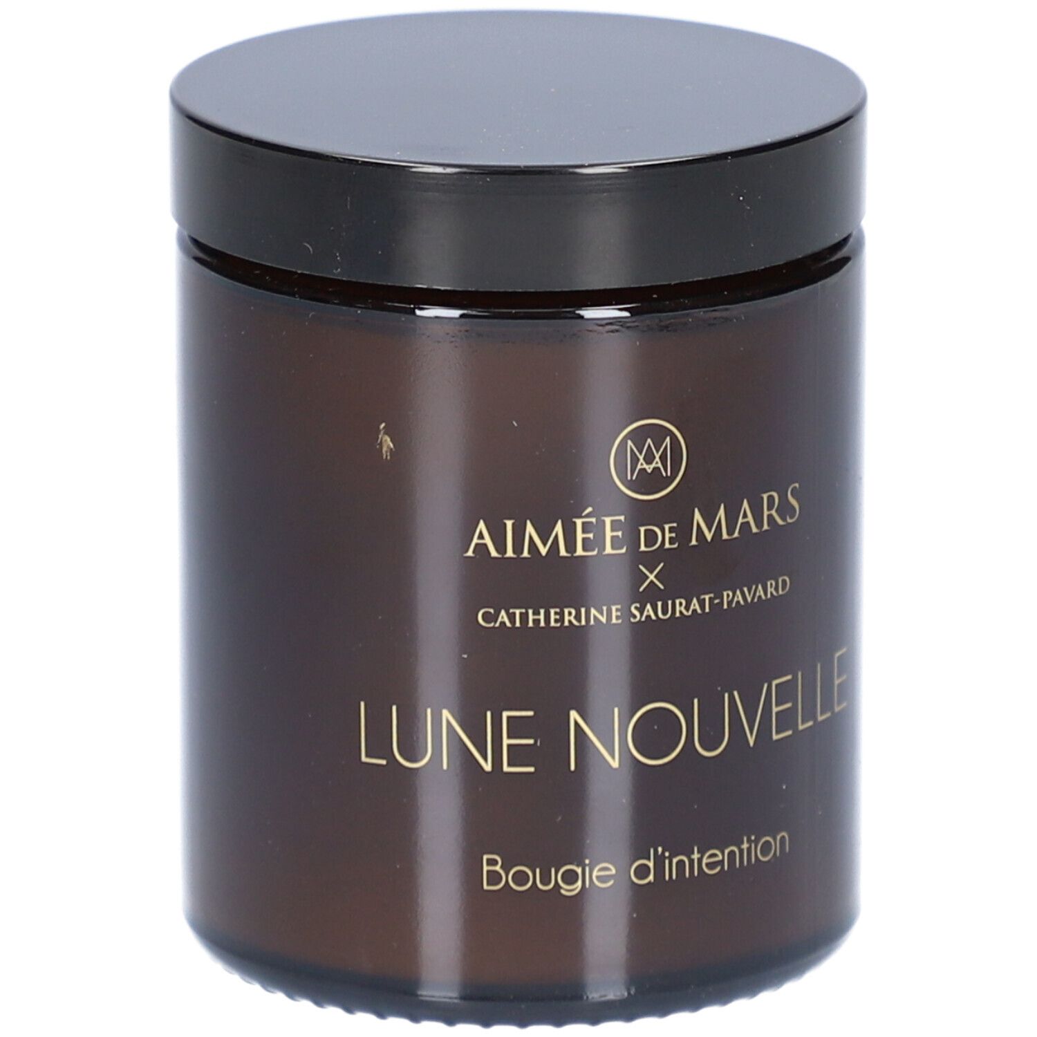 Bruine glazen pot met zwarte deksel. Opschrift: AIMÉE DE MARS x Catherine Saurat-Pavard, Lune Nouvelle, Bougie d'intention.