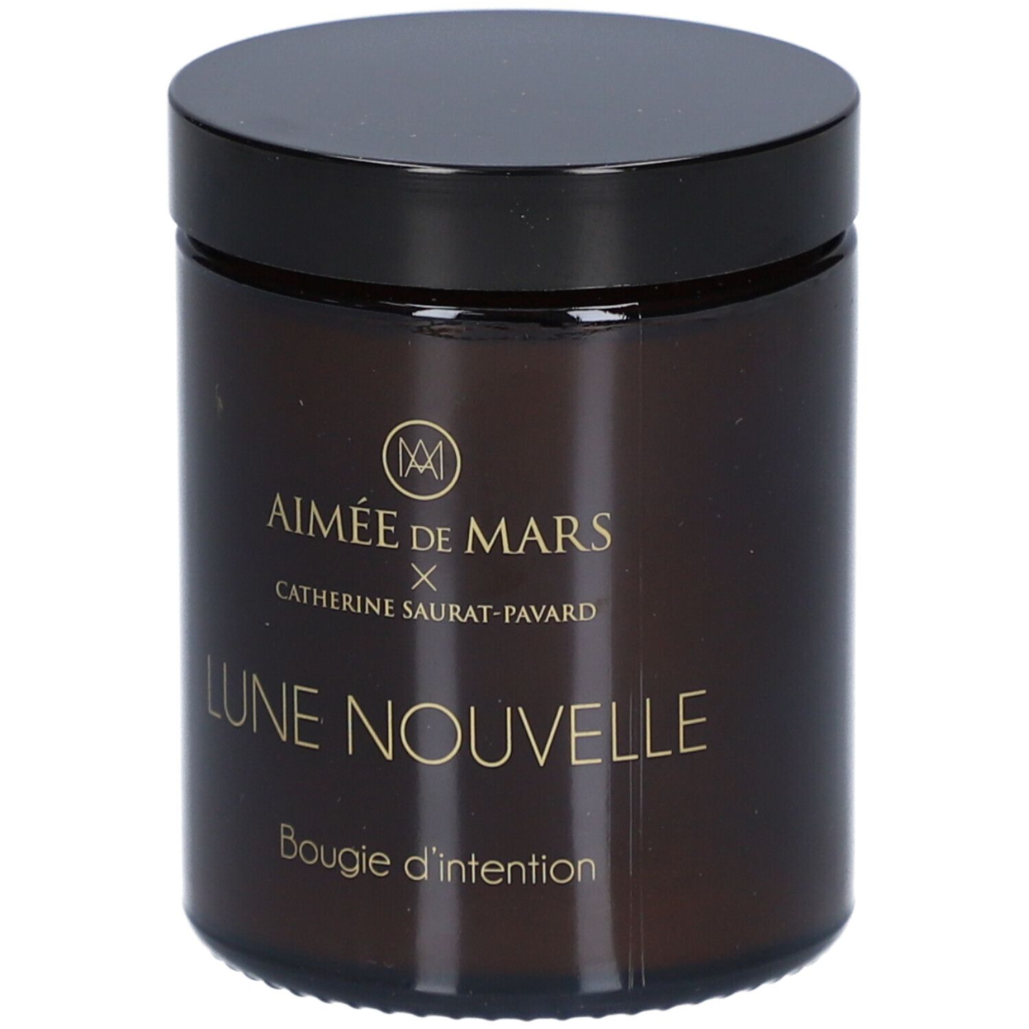 Bruine glazen pot met zwarte deksel. Opschrift: AIMÉE DE MARS x Catherine Saurat-Pavard, Lune Nouvelle, Bougie d'intention.