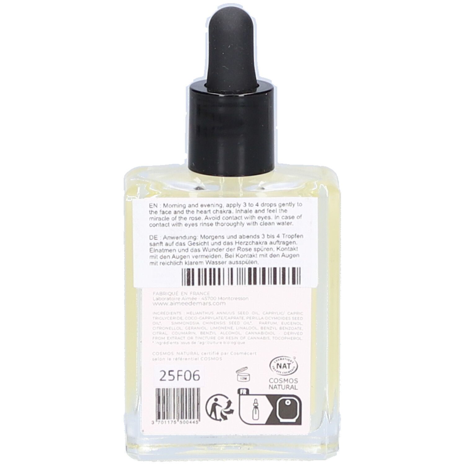 Achterkant van de glazen fles met tekst en etiket. Bevat gebruiksinformatie en het Cosmos Natural-label.