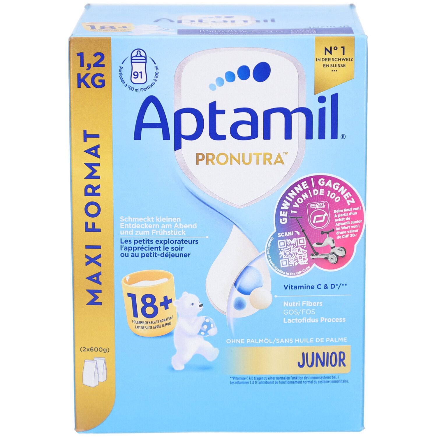 Kartonnen verpakking, blauw en wit. Bevat Aptamil Pronutra Juniormilch 18+. Maxi Formaat 1,2 kg. Met illustraties.
