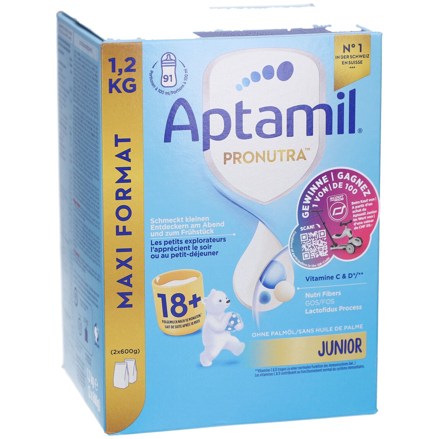 Kartonnen verpakking, blauw en wit. Bevat Aptamil Pronutra Juniormilch 18+. Maxi Formaat 1,2 kg. Met illustraties.