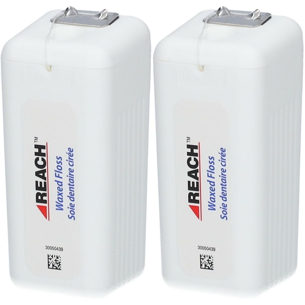 Deux boîtes blanches de fil dentaire avec sortie métallique. Inscription: REACH Waxed Floss, Soie dentaire cirée.