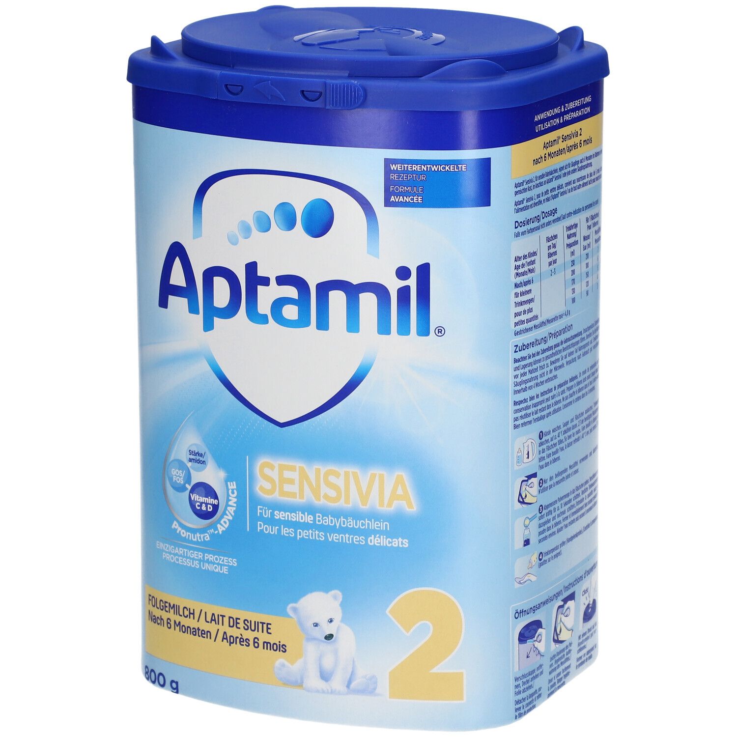 Boîte de lait en poudre Aptamil Sensivia 2. Design bleu et blanc avec nom du produit, ingrédients et dosage. Contient des vitamines C et D.
