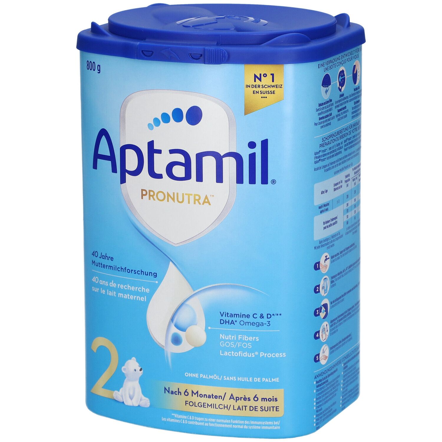 Boîte de lait de suite Aptamil Pronutra 2. Bleue, avec couvercle. 800g. Contient Vitamine C & D, DHA Omega-3. Logo et texte.