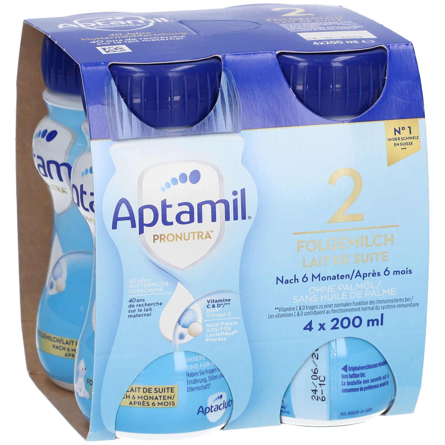 Emballage de quatre bouteilles Aptamil 2 Lait de suite. Bouteilles bleues avec bouchons bleus, dans un emballage en carton. Inscriptions : Aptamil, 2, Lait de suite.