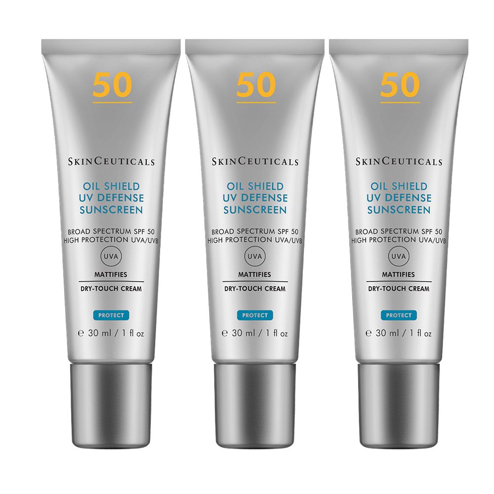 Trois tubes de crème solaire SkinCeuticals. Tubes argentés avec "50" jaune. Inscription : OIL SHIELD UV DEFENSE SUNSCREEN, SPF 50.