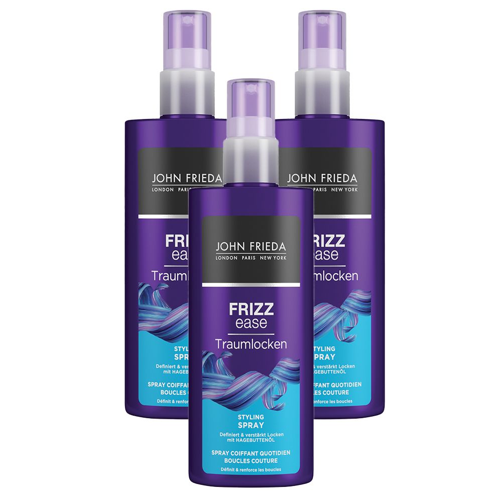 Trois flacons de spray coiffant JOHN FRIEDA Frizz ease Traumlocken. Flacons violets avec vaporisateur blanc et nom du produit.