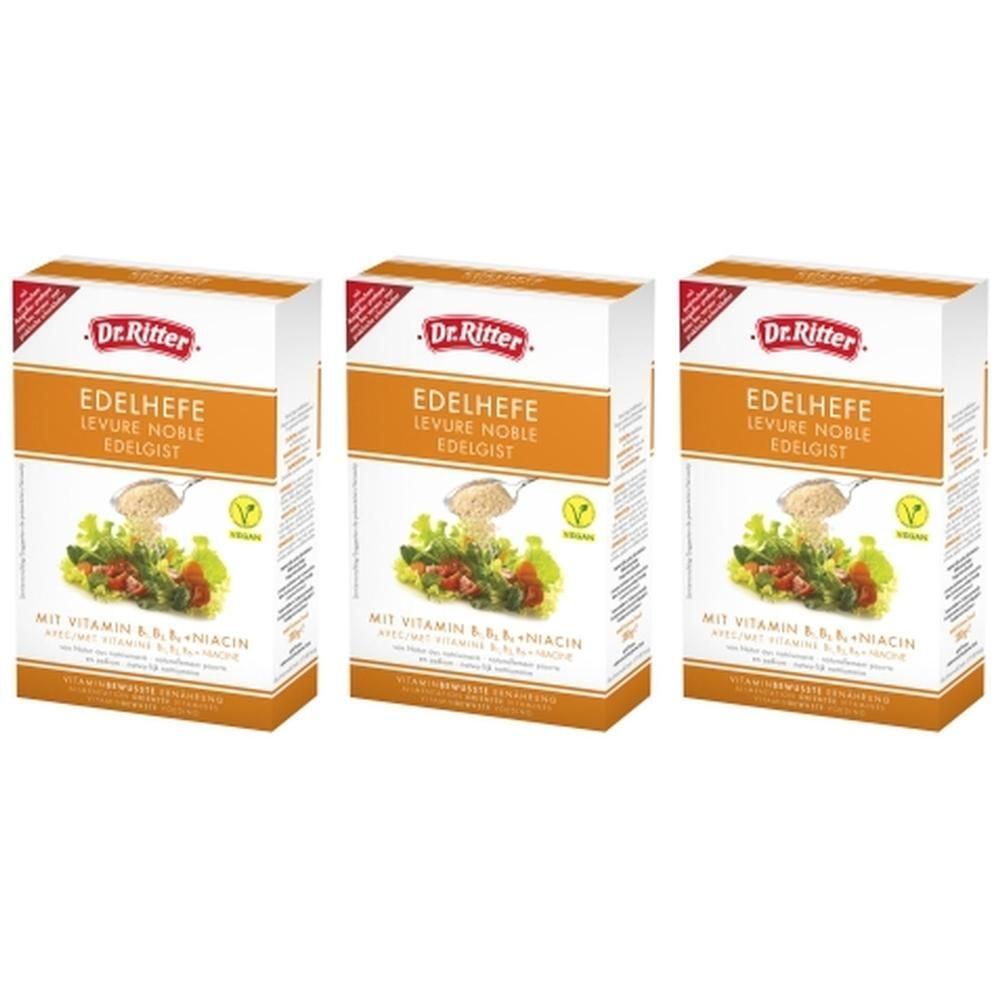 Drie dozen DR. Ritter Edelhefe vlokken. Wit-oranje verpakking met productnaam, afbeelding en vegan logo.