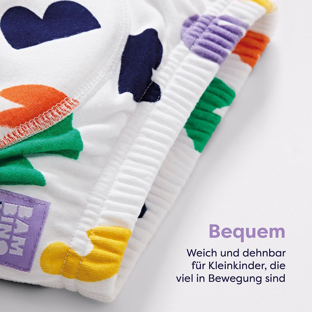 Witte oefenbroek met kleurrijke vormen. Tekst: Comfortabel. Zacht en rekbaar voor peuters.