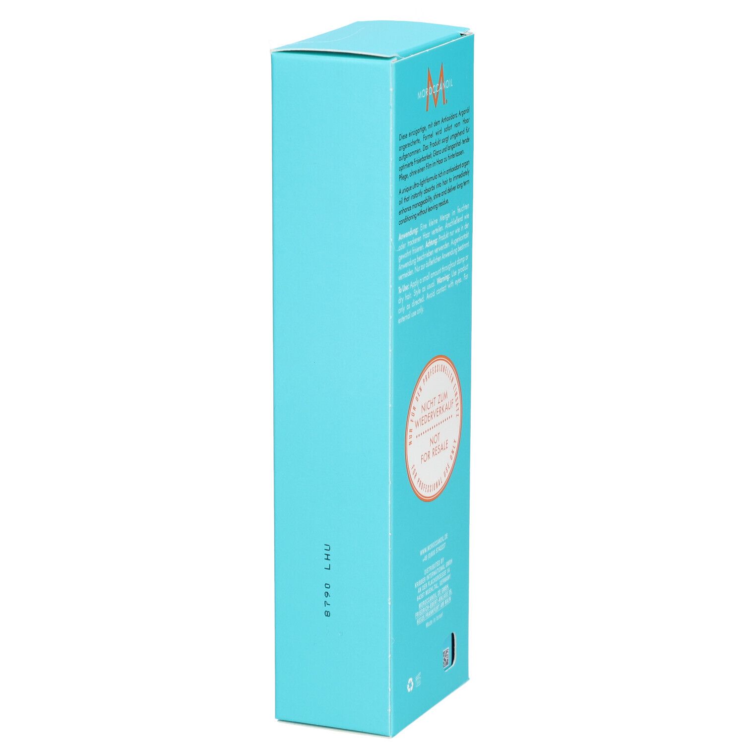 Boîte turquoise avec logo Moroccanoil et informations produit. Comprend une mention circulaire.