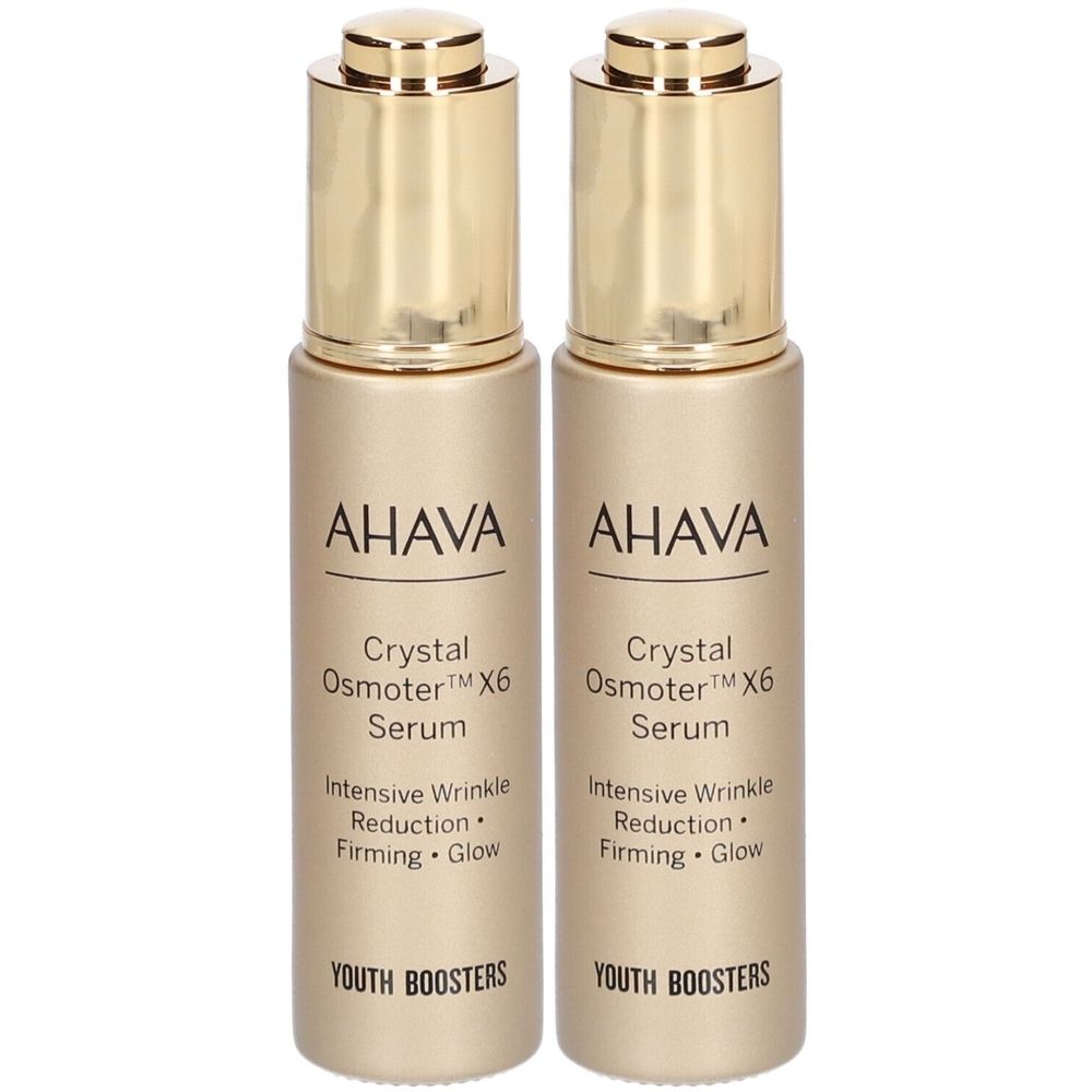 Twee serumflacons. Gouden dop, opschrift AHAVA, Crystal Osmoter X6 Serum, Youth Boosters.