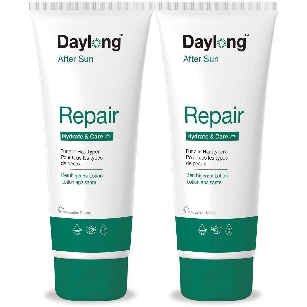 Twee witte tubes met groene tekst. Opschrift: Daylong After Sun Repair, Hydrate & Care. Voor alle huidtypen.