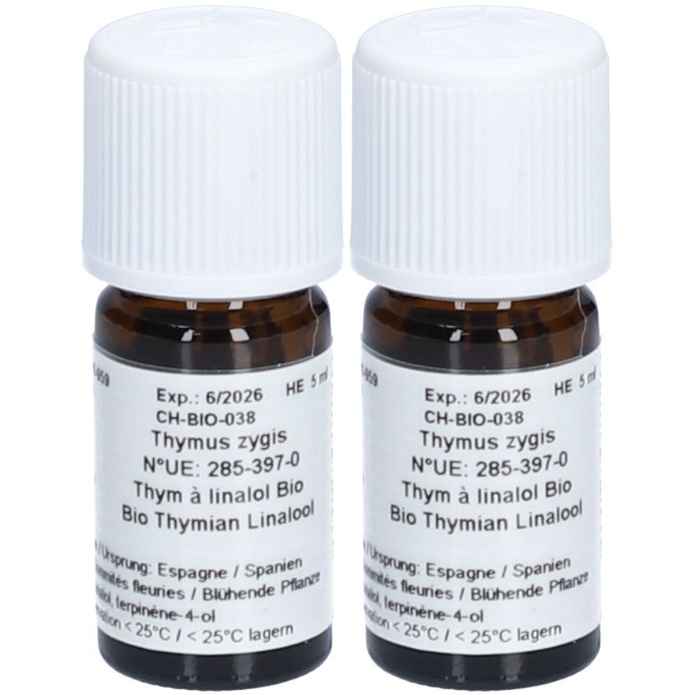 Deux petites bouteilles en verre brun avec des bouchons à vis blancs. Étiquettes avec texte, dont 'Thymus zygis' et 'Bio Thymian Linalool'.