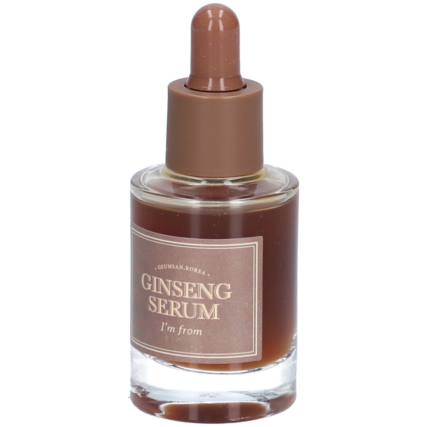 Glazen fles met bruine vloeistof en bruine dop. Op het etiket staat "Ginseng Serum" en "I'm from".