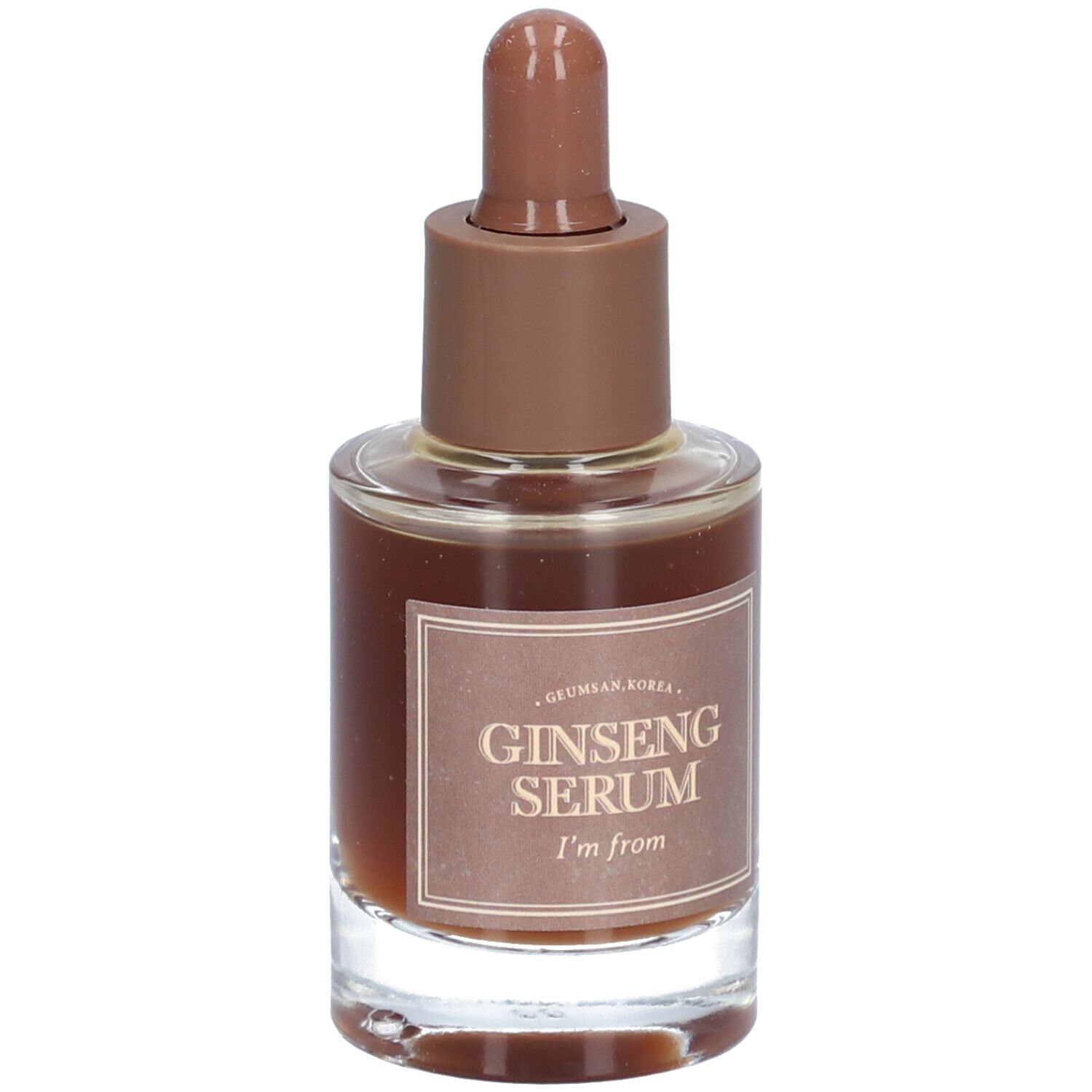 Glazen fles met bruine vloeistof en bruine dop. Op het etiket staat "Ginseng Serum" en "I'm from".