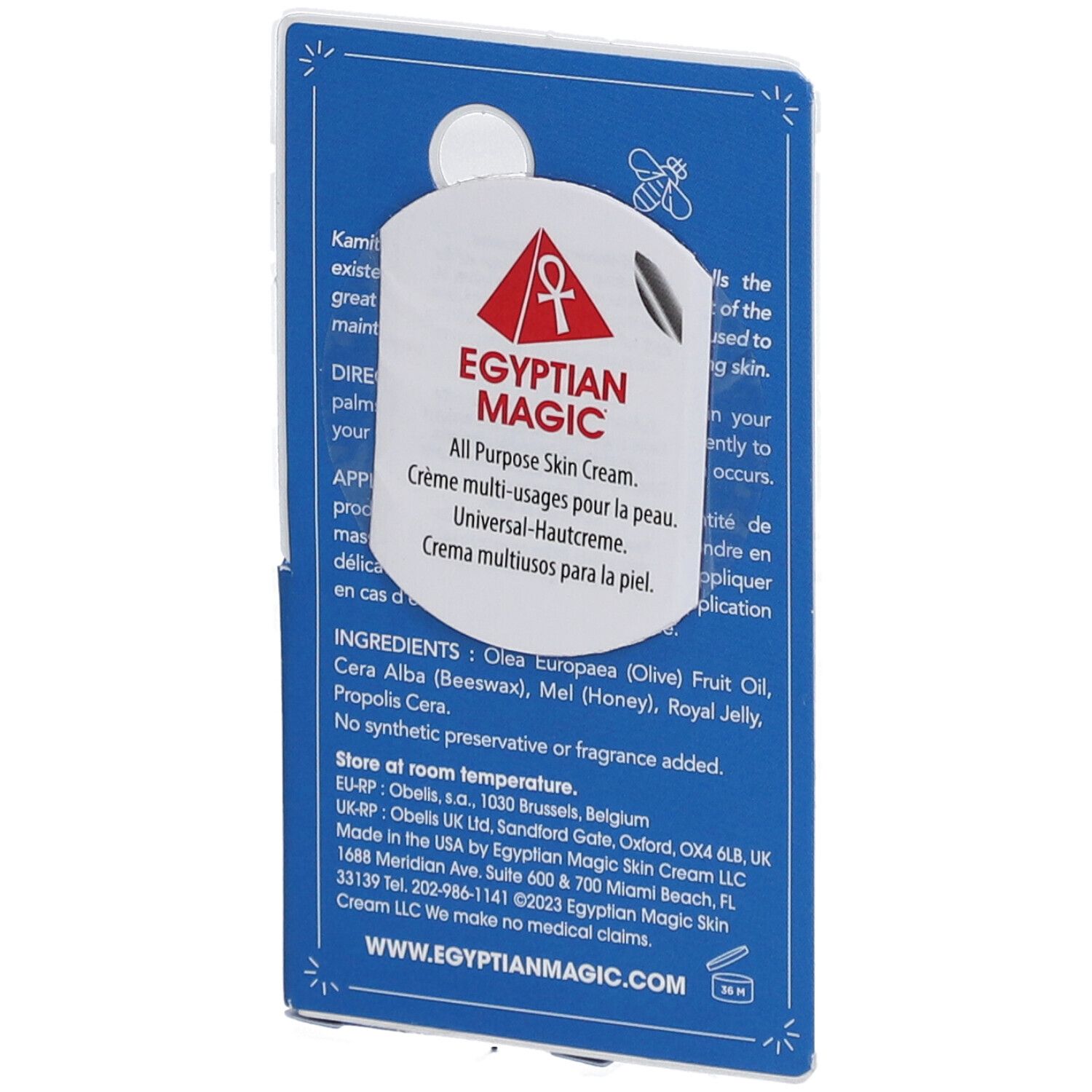 Dos d'un présentoir en carton bleu. Texte : Egyptian Magic, All Purpose Skin Cream. Ingrédients, instructions d'utilisation.