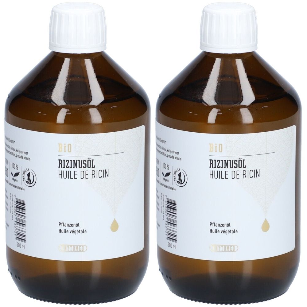 Twee bruine glazen flessen met witte doppen. Labels: "BIO RIZINUSÖL HUILE DE RICIN".
