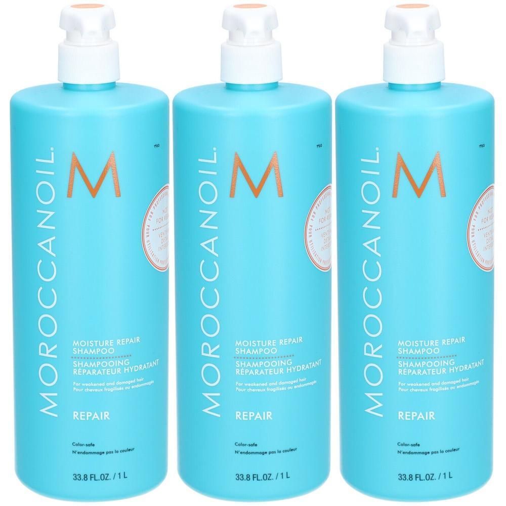 Trois bouteilles de Moroccanoil Moisture Repair Shampoo, turquoise, avec distributeur à pompe. Chaque bouteille présente le logo 'M' et des informations produit.